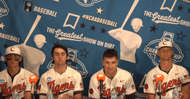 Clemson baseball players sit with head coach Erik Bakich at a press conference during the 2024 NCAA baseball tournament